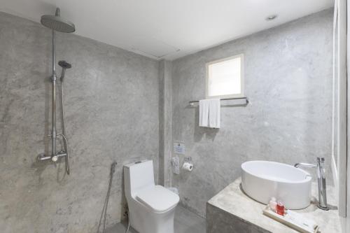 a bathroom with a shower and a toilet and a sink at Sea Hills Resort in Patong Beach