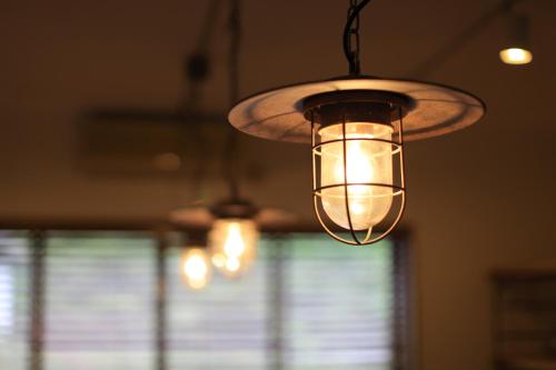 a chandelier hanging from a ceiling with a window at Yakushima Minsyuku Suginoko in Yakushima