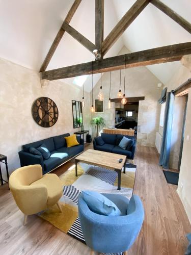 a living room with blue couches and a table at gite du perche in Bueil