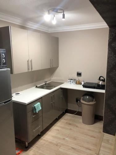 a kitchen with a sink and a counter top at Annies Place Self Catering in Kempton Park