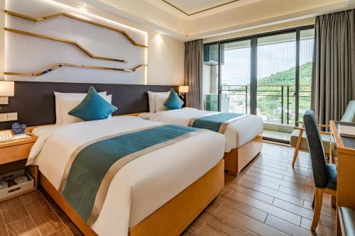 Кровать или кровати в номере Dingshang Apartment Hotel