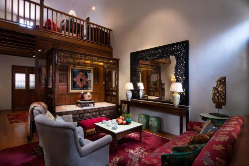 
a living room filled with furniture and a fireplace at Seven Terraces in George Town
