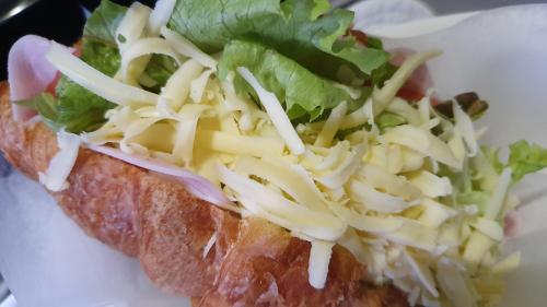 a sandwich with cheese and lettuce on a white plate at Keret Accommodation in Bellville