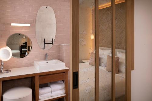 a bathroom with a sink and a mirror at Hôtel des Champs-Elysées in Paris