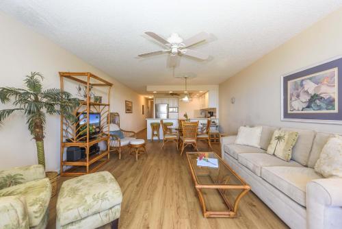 a living room with a couch and a table at Kahana Villa F406 in Lahaina