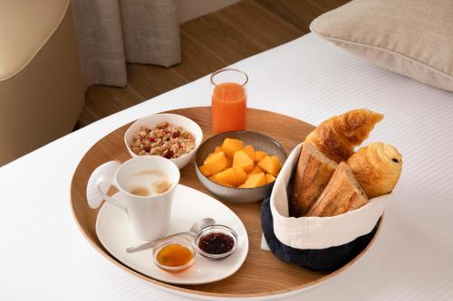 a tray of breakfast food on a table at Hôtel des Champs-Elysées in Paris