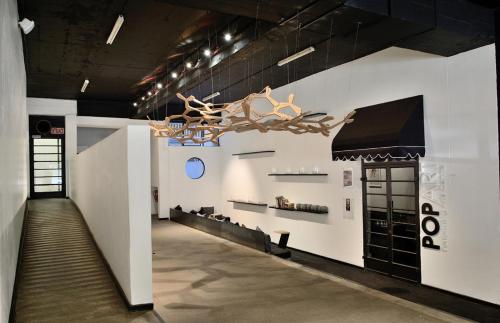 a hallway in a building with a large chandelier at Stunning Maboneng Precinct Studio Apartment at 12 Decades Building in Johannesburg