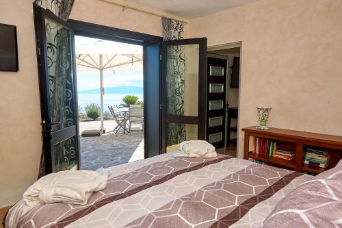 a bedroom with a bed and an open door to a patio at Finca el Vinche in Guía de Isora