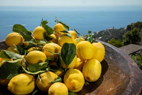 a pile of lemons sitting on top of a table at Monastero Santa Rosa Hotel & Spa in Conca dei Marini