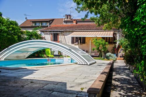 a bridge over a swimming pool in front of a house at La petite Pierrette in Saint-Benoît-de-Carmaux