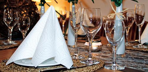 a table with wine glasses and a plate with napkins at Hotel Eberbacher Hof in Biberach an der Riß