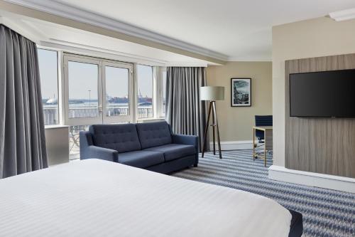 a living room filled with furniture and a window at Leonardo Royal Southampton Grand Harbour in Southampton