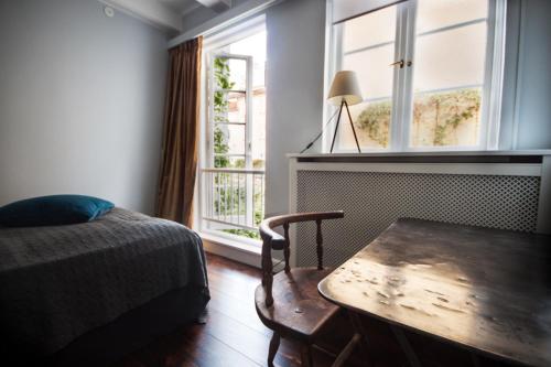 una camera da letto con un tavolo, un letto e una finestra di Sankt Annæ 10 a Copenaghen