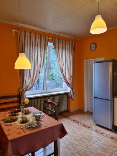 a kitchen with a table and a refrigerator at Bei Chogman in Gronau