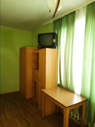 een kamer met een tafel en een tv op een kast bij Квартира рядом с парком Б. Хмельницкого (центр) из первых рук in Chernihiv
