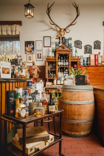 a bar with a barrel and a counter with alcohol at Hotel Drei Hasen in Mariazell