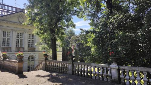 a fence in front of a house with flowers at Pokoje Gościnne Pałac w Balicach Instytut Zootechniki PIB in Balice