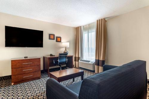 a hotel room with a couch and a television at Comfort Inn & Suites Athens North in Athens