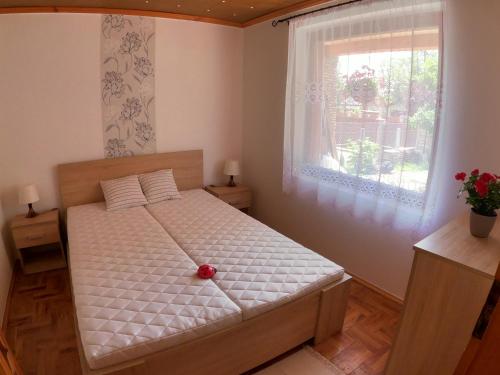 a bedroom with a bed with a red ball on it at Katica Nyaraló in Tiszakécske