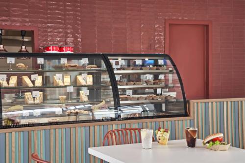 a table in a bakery with a display case at Mare Paphos in Paphos