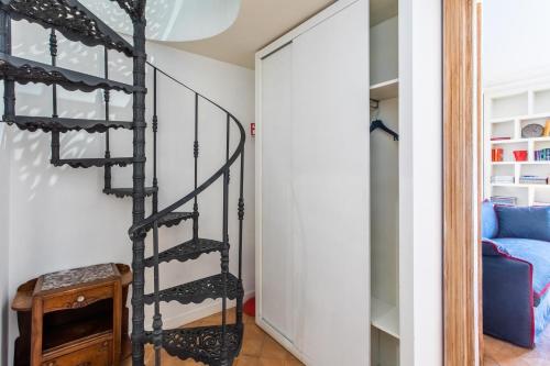 a spiral staircase in a room with a bed at Frattina Apartments in Rome