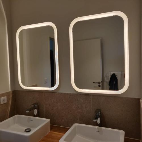 - deux miroirs au-dessus d'un lavabo blanc dans la salle de bains dans l'établissement Mas Partout, à Malaucène