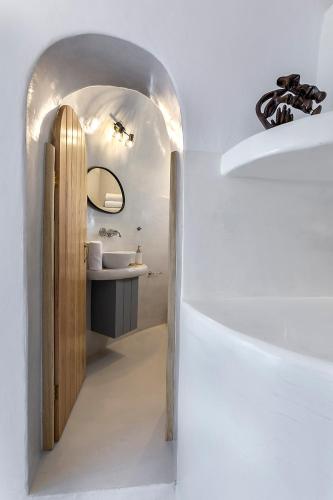 a bathroom with a sink and a mirror at Antron Cave House in Akrotiri