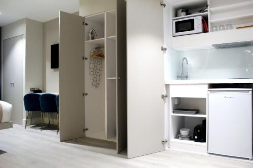 a kitchen with a door open into a room at NOX Waterloo in London