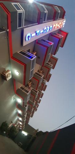 a building with a neon sign on the side of it at Hotel Pacific, Lda in Cidade de Nacala