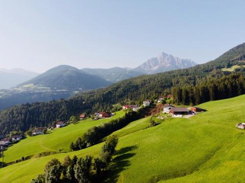 a grassy hillside with a mountain range at Hoarachhof in Innsbruck