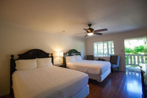 a bedroom with two beds and a ceiling fan at The Jack London Lodge in Glen Ellen