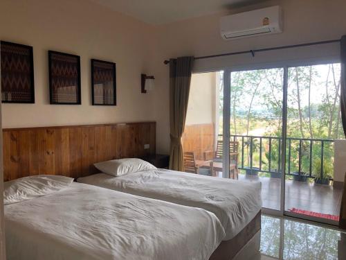 Postel nebo postele na pokoji v ubytování มิตรภาพโฮเทล ( Mittrapap Hotel )