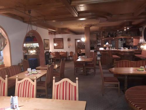 a dining room with wooden tables and chairs at Hotel Eberbacher Hof in Biberach an der Riß