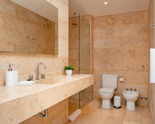 a bathroom with a toilet and a sink and a shower at Ara Homes Buenos Aires in Buenos Aires