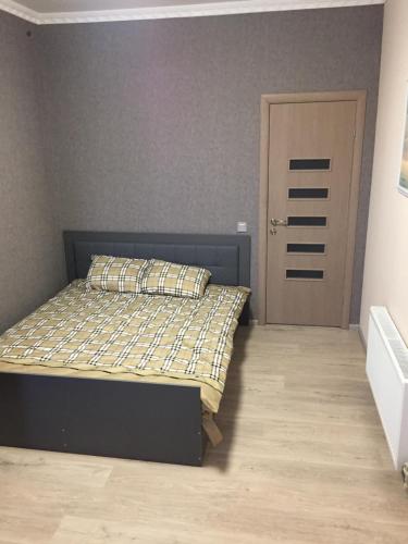 ein Schlafzimmer mit einem Bett und einer Tür in der Unterkunft Отель Переулок средний 16 in Kropywnyzkyj