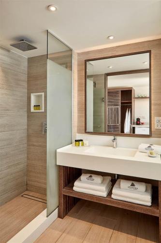 a bathroom with a sink and a mirror at Mare Ayia Napa in Ayia Napa