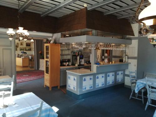 ein Restaurant mit einer Theke und einer Bar in einem Zimmer in der Unterkunft Hoffmanns Nordfriesisches Haus in Tönning