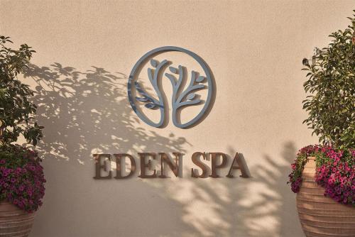 a sign on the side of a building with flowers at Mare Ayia Napa in Ayia Napa