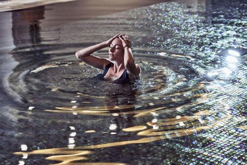 a woman is standing in a pool of water at Mare Ayia Napa in Ayia Napa