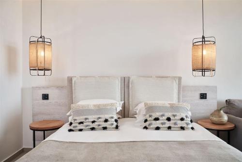 a bedroom with a white bed with two pillows at Mare Ayia Napa in Ayia Napa