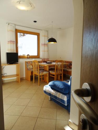 a kitchen with a table and chairs and a dining room at Schötzerhof in Meltina