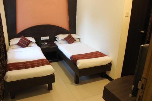 a hotel room with two beds in a room at Hotel Fortune in Mumbai