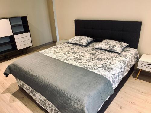 a bedroom with a large bed with two pillows on it at Sepa Apartment in Valga
