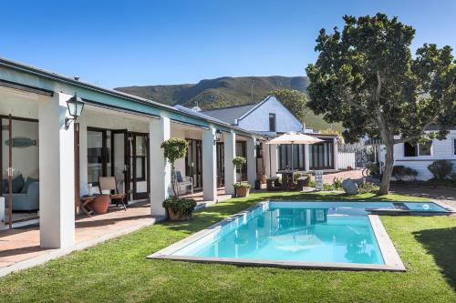 a swimming pool in the yard of a house at Sixteen Guesthouse on Main in Hermanus