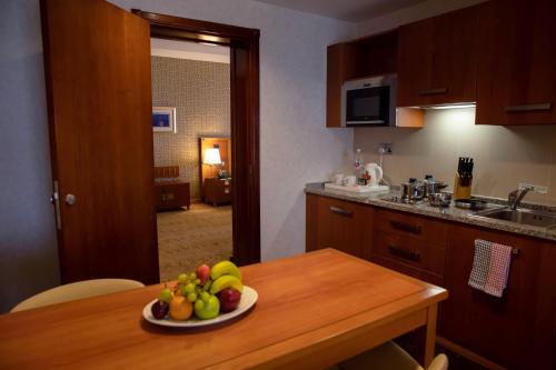 a kitchen with a plate of fruit on a table at Holiday Inn - Suites Kuwait Salmiya by IHG in Kuwait