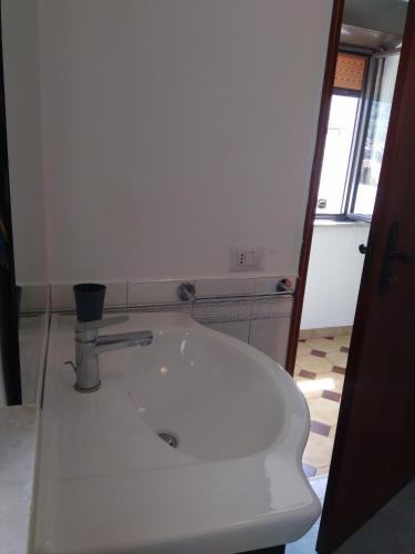 a white bath tub in a room with a window at Galatro Terme House in Galatro