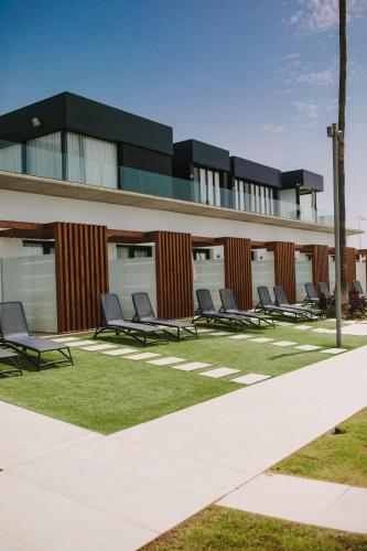 a row of chairs sitting in front of a building at Club Maspalomas Suites & Spa - Adults Only in Maspalomas