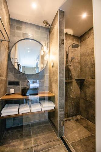 a bathroom with a shower and a mirror at Domburg Holiday Resort in Domburg