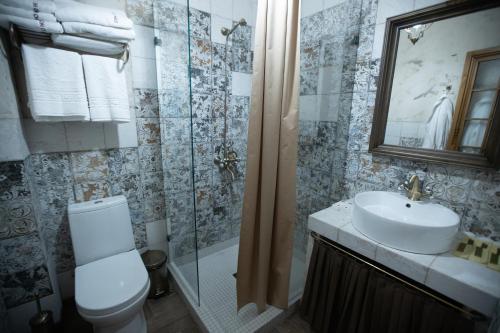 a bathroom with a toilet and a sink and a shower at Boutique ETHNO HOTEL in Gyumri