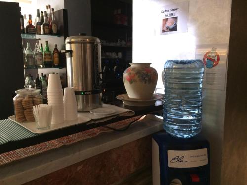 a bar with a bottle of water on a counter at Eraclea Palace Appartements in Eraclea Mare
